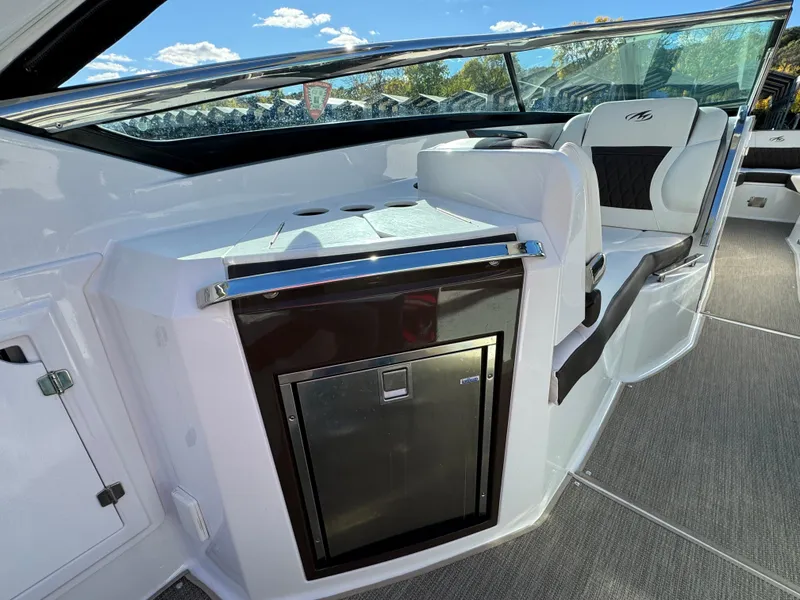 Slide: The Image of 2018 Monterey 328 Super Sport boat interior with seating and storage. - 14