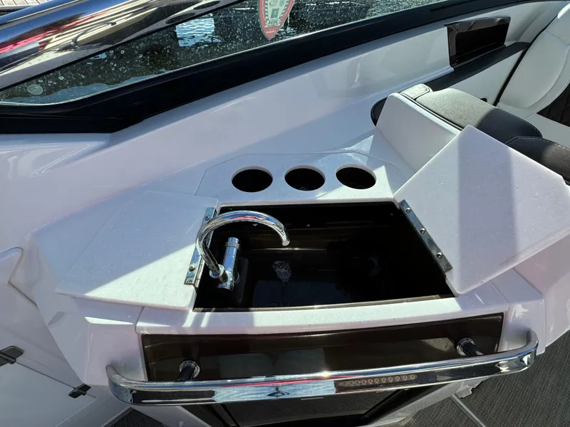Slide: The Image of 2018 Monterey 328 Super Sport boat interior with sink and cup holders. - 15