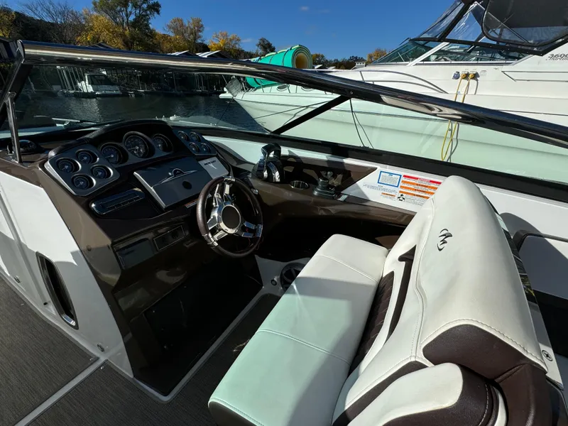 Slide: The Image of 2018 Monterey 328 Super Sport boat interior with steering wheel and dashboard. - 18