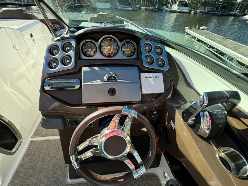 Slide: The Image of 2018 Monterey 328 Super Sport boat dashboard with steering wheel and control panel. - 19