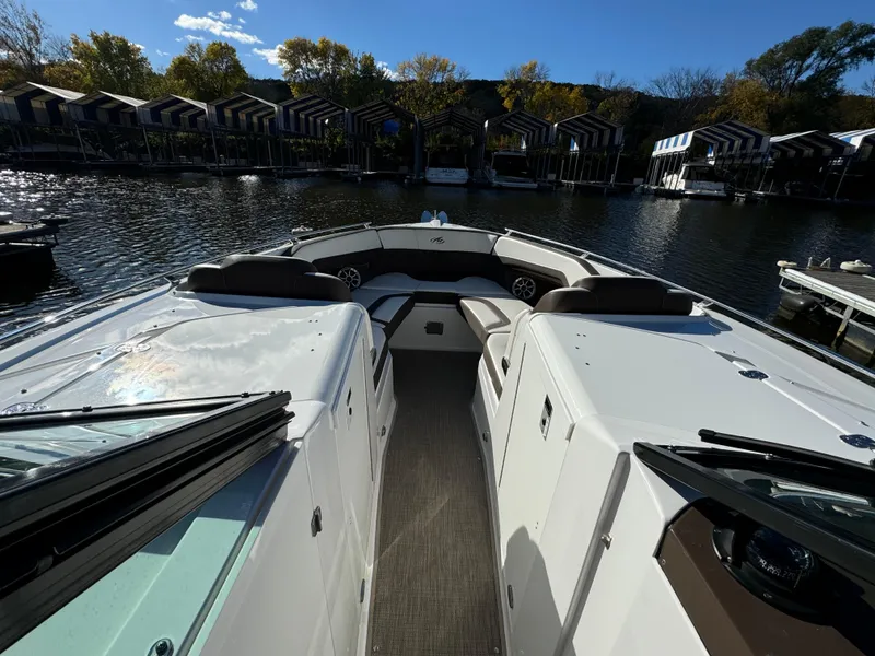 Slide: The Image of 2018 Monterey 328 Super Sport boat docked at a scenic marina. - 23