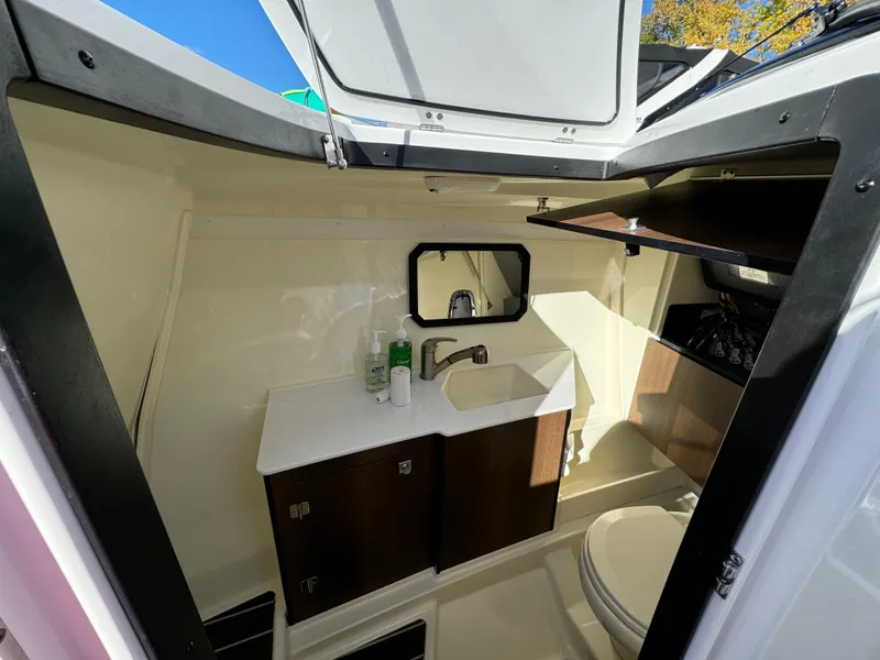 Slide: The Image of Interior of 2018 Monterey 328 Super Sport boat bathroom with sink and toilet. - 28