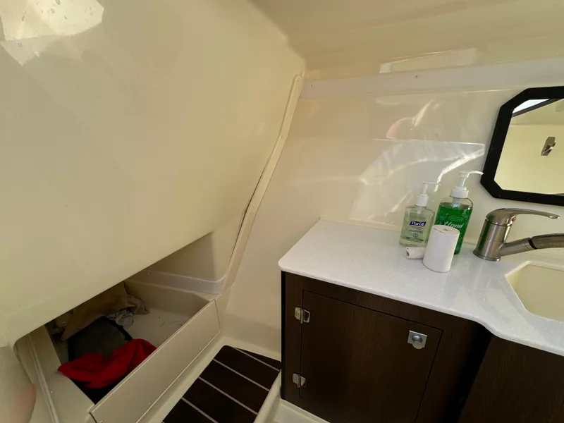 Slide: The Image of Interior of 2018 Monterey 328 Super Sport boat with sink and storage area. - 29