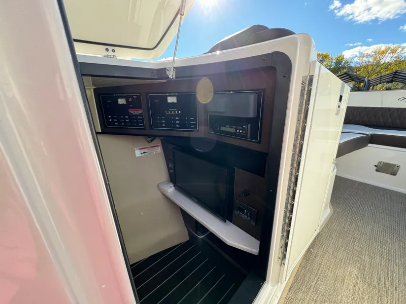 Slide: The Image of Interior view of 2018 Monterey 328 Super Sport boat with control panels and seating. - 33