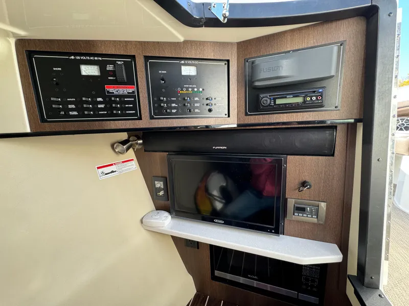 Slide: The Image of Control panel and entertainment system inside a 2018 Monterey 328 Super Sport boat. - 34