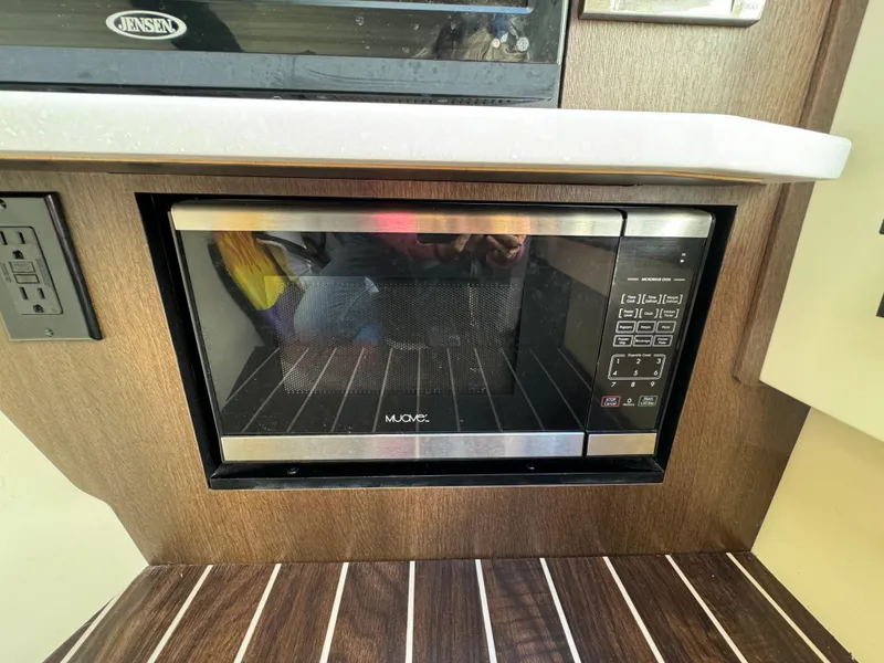 Slide: The Image of Built-in microwave in 2018 Monterey 328 Super Sport boat kitchen area. - 35