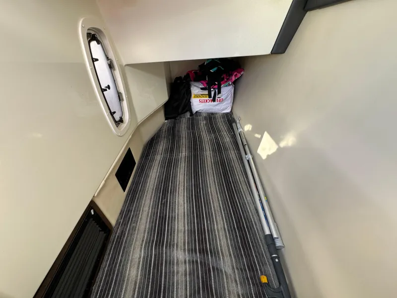 Slide: The Image of 2018 Monterey 328 Super Sport cabin interior with striped flooring and storage items. - 38