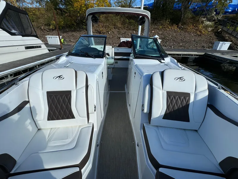 Slide: The Image of 2018 Monterey 328 Super Sport boat interior with luxurious seating at a dock. - 42