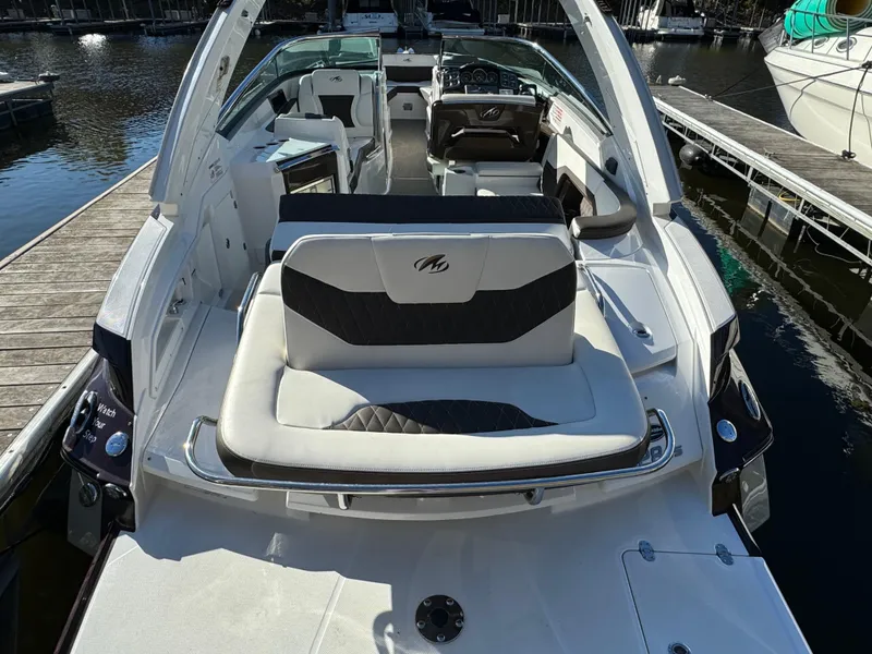 Slide: The Image of 2018 Monterey 328 Super Sport boat interior with seating, docked by the water. - 8