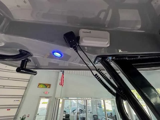 Slide: The Image of Interior view of 2025 Sportsman Open 212 boat with Garmin device and blue LED light. - 13