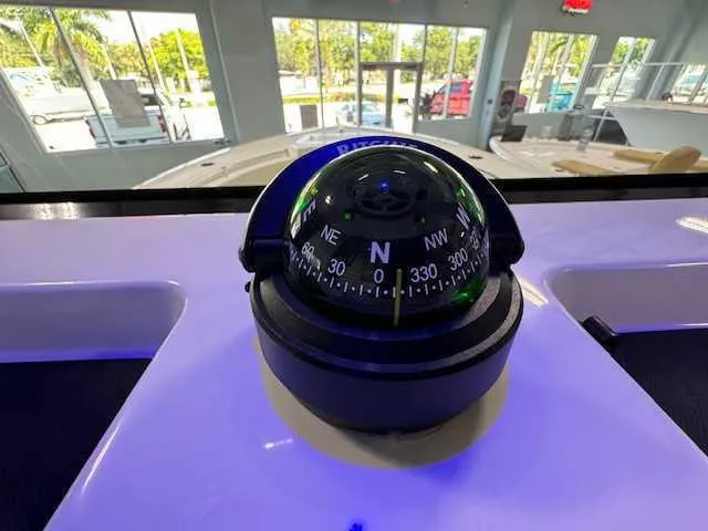 Slide: The Image of Compass on 2025 Sportsman Open 212 boat dashboard in showroom. - 17