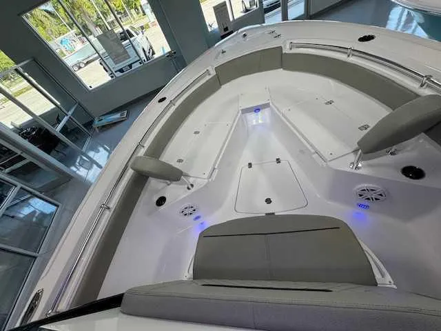 Slide: The Image of 2025 Sportsman Open 212 boat interior with cushioned seating and LED lighting. - 19