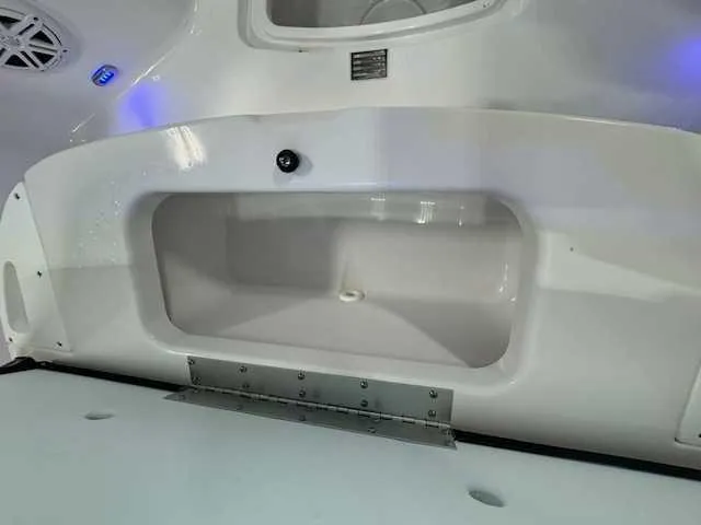 Slide: The Image of 2025 Sportsman Open 212 boat interior storage compartment with sleek white finish. - 21