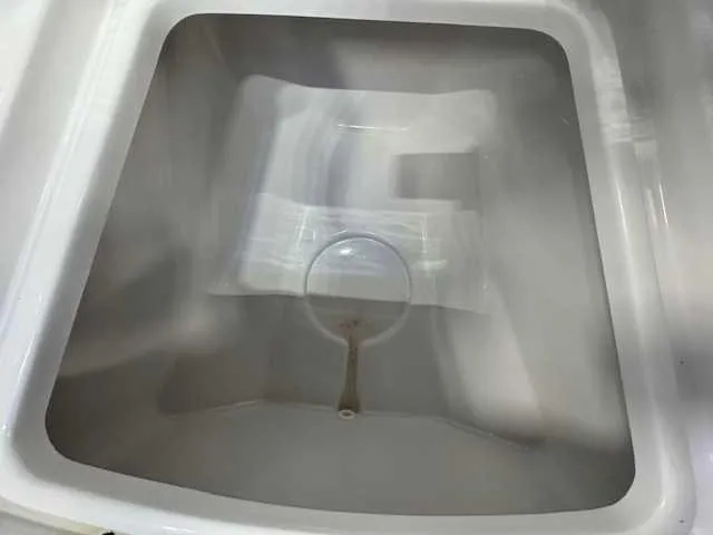 Slide: The Image of 2025 Sportsman Open 212 boat compartment interior, white and clean design. - 22