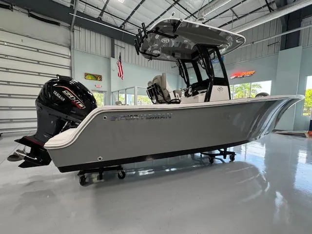 Slide: The Image of 2025 Sportsman Open 212 boat in showroom, featuring sleek design and powerful engine. - 29