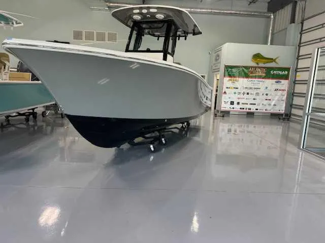 Slide: The Image of 2025 Sportsman Open 212 boat displayed in a showroom. - 31