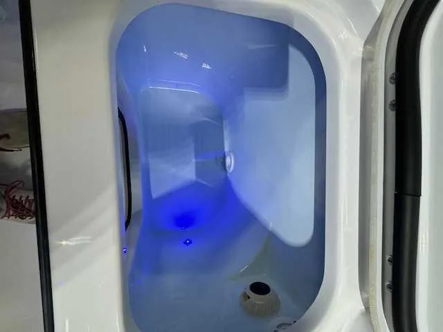 Slide: The Image of 2025 Sportsman Open 212 boat interior with modern seating and overhead lighting in showroom. - 39