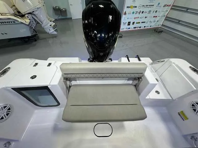 Slide: The Image of 2025 Sportsman Open 212 boat interior with seating and motor, in showroom setting. - 5