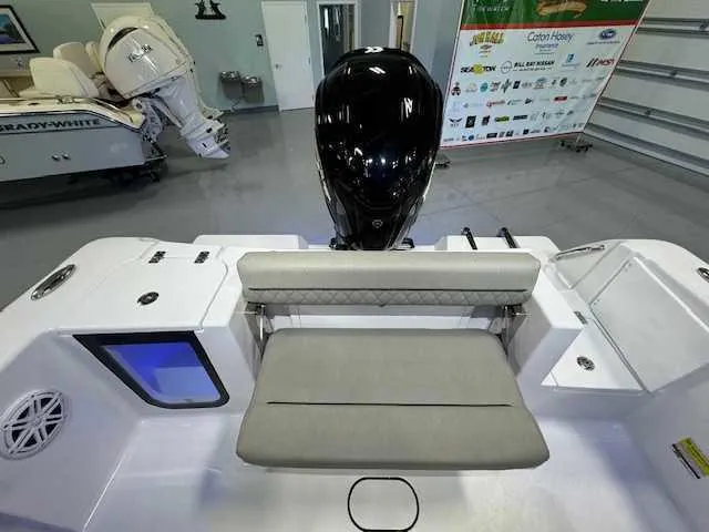 Slide: The Image of 2025 Sportsman Open 212 boat interior with seating and motor in showroom. - 6