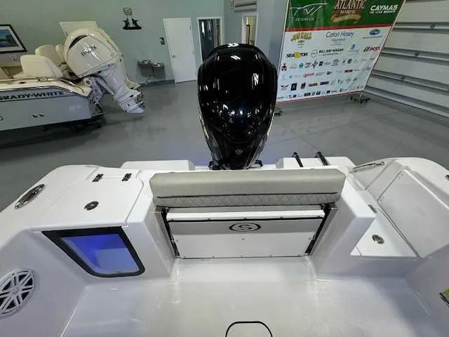 Slide: The Image of 2025 Sportsman Open 212 boat interior with motor, showroom display. - 7