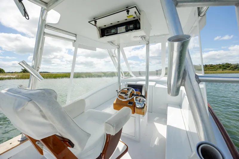 Slide: The Image of 2005 Custom Carolina 26 Tideline Boatworks Express helm with scenic water view. - 10
