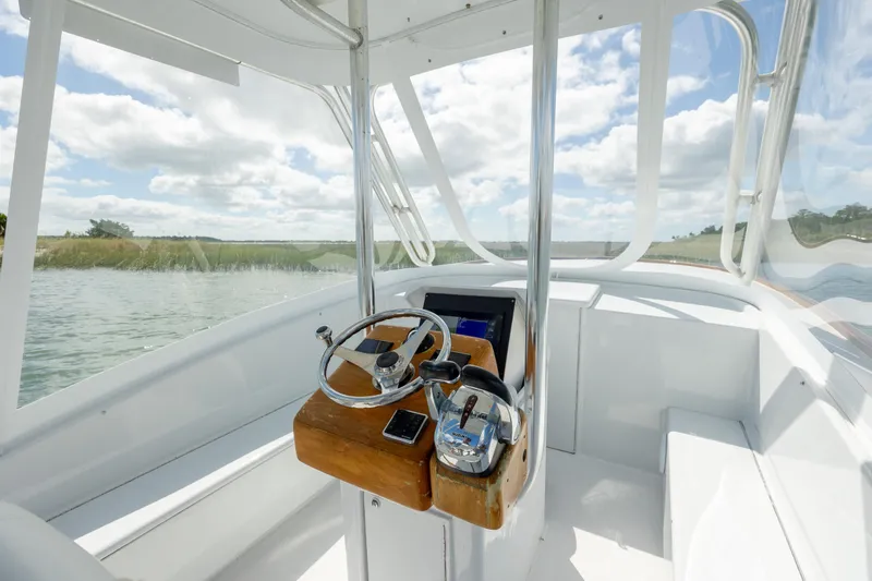 Slide: The Image of Interior view of 2005 Custom Carolina 26 Tideline Boatworks Express, featuring helm and controls. - 13