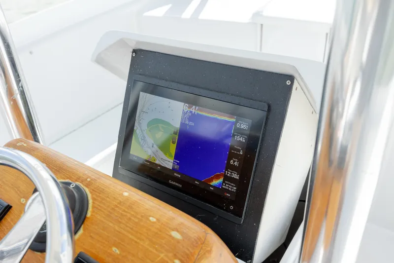 Slide: The Image of Close-up of 2005 Custom Carolina 26 Tideline Boatworks Express dashboard with navigation display. - 14