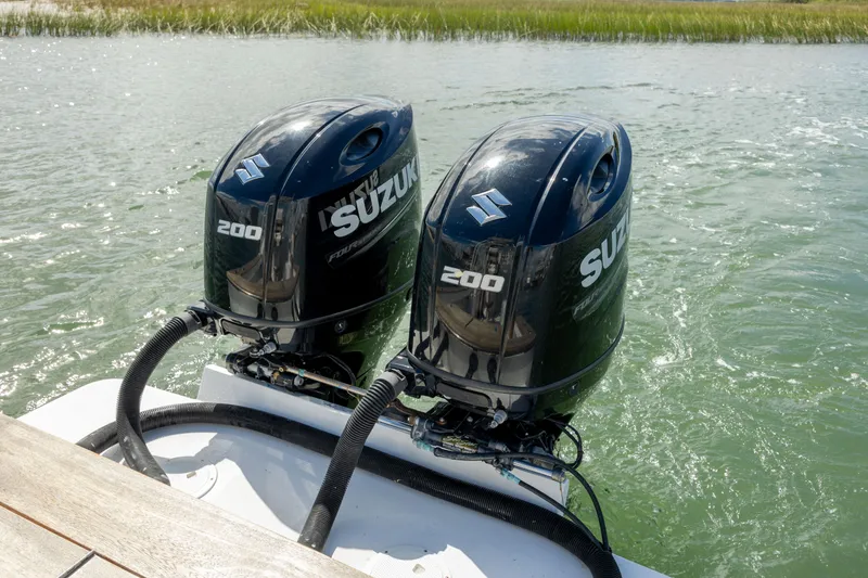 Slide: The Image of Twin Suzuki outboard engines on 2005 Custom Carolina 26 Tideline Boatworks Express. - 18