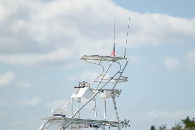 Slide: The Image of Custom Carolina 26 Tideline Boatworks Express 2005 with tower against cloudy sky. - 8