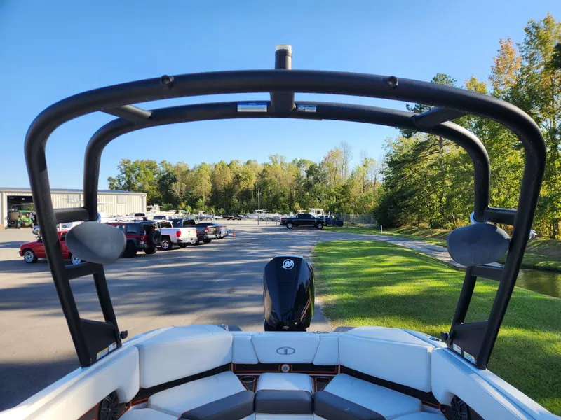 Slide: The Image of 2021 Tahoe 210 S boat with wakeboard tower in a parking lot. - 16