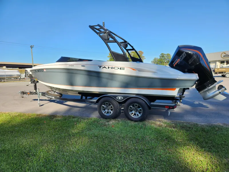 Slide: The Image of 2021 Tahoe 210 S boat on trailer, parked outdoors, side view. - 5