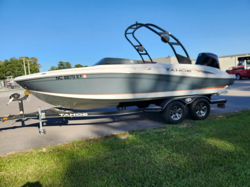 Slide: The Image of 2021 Tahoe 210 S boat on trailer, parked outdoors on grass. - 6