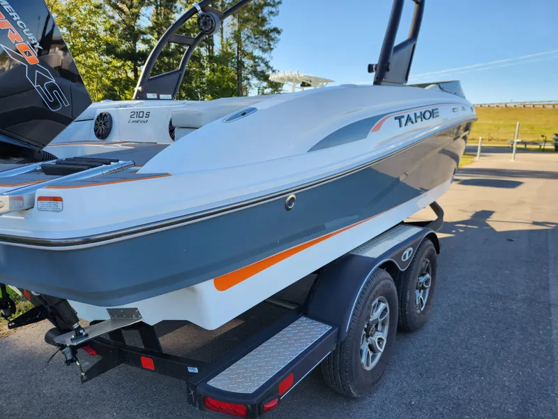 Slide: The Image of 2021 Tahoe 210 S boat on trailer, sleek design, parked outdoors. - 7