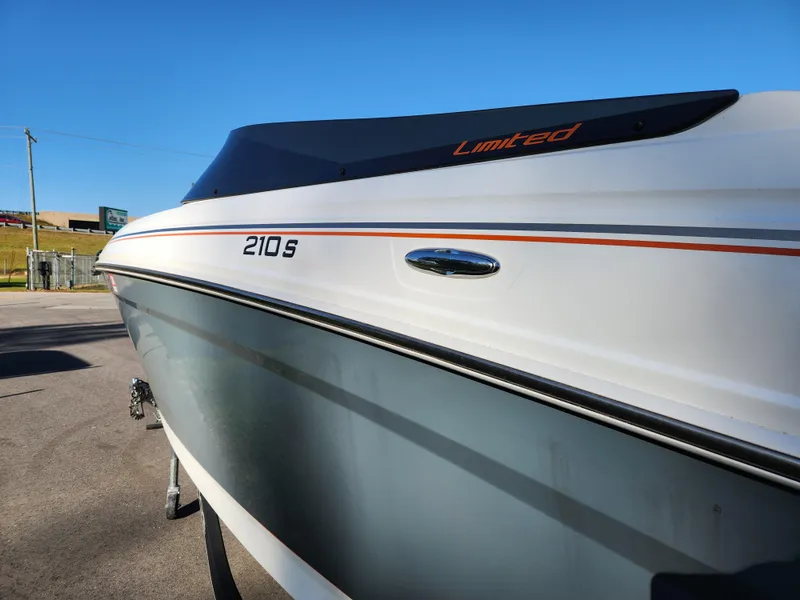 Slide: The Image of 2021 Tahoe 210 S boat, sleek design, Limited edition, parked outdoors. - 8