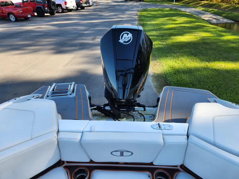 Slide: The Image of 2021 Tahoe 210 S boat with outboard motor, parked on a sunny street. - 9