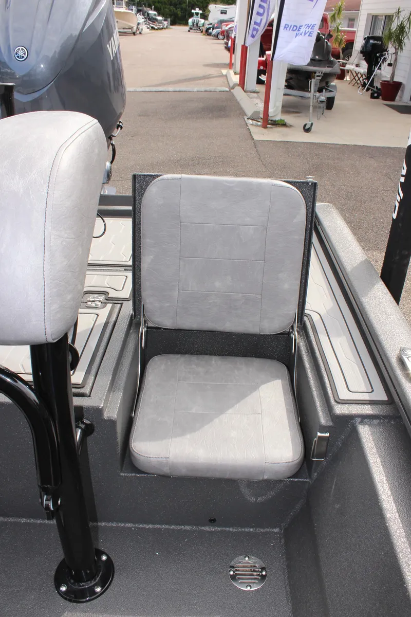 Slide: The Image of 2025 Avid 21 FSX boat with gray seating and Yamaha motor in a showroom. - 11