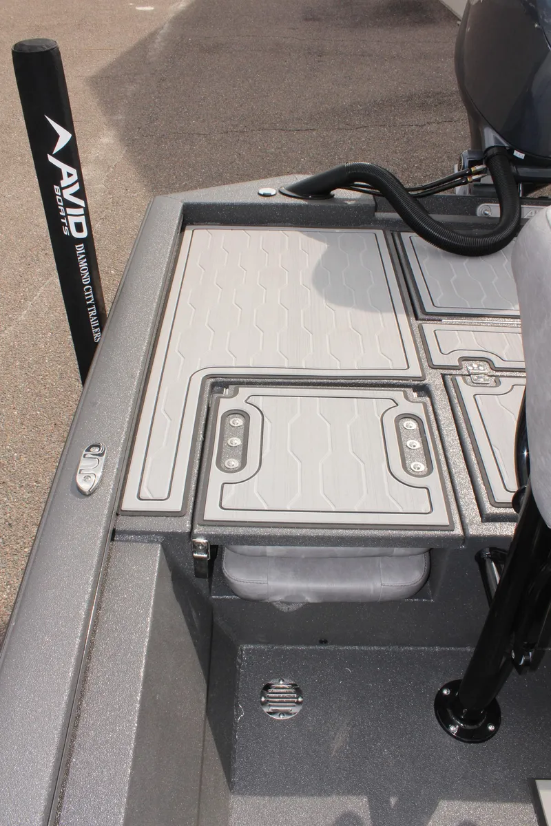 Slide: The Image of Avid 21 FSX 2025 boat deck with storage compartments and sleek design. - 12