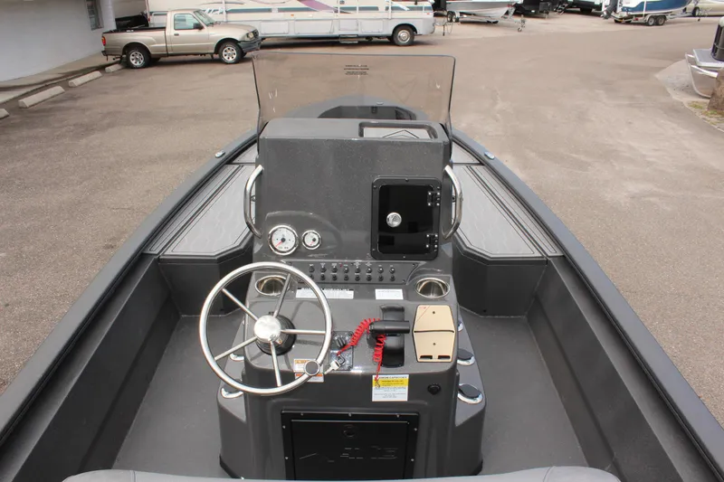 Slide: The Image of 2025 Avid 21 FSX boat interior with steering wheel and control panel. - 15