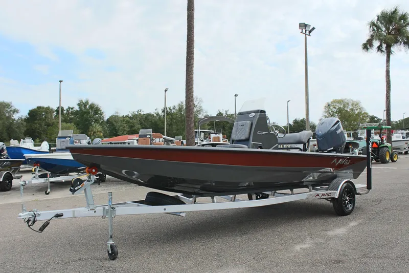 Slide: The Image of 2025 Avid 21 FSX boat on trailer in outdoor setting. - 2