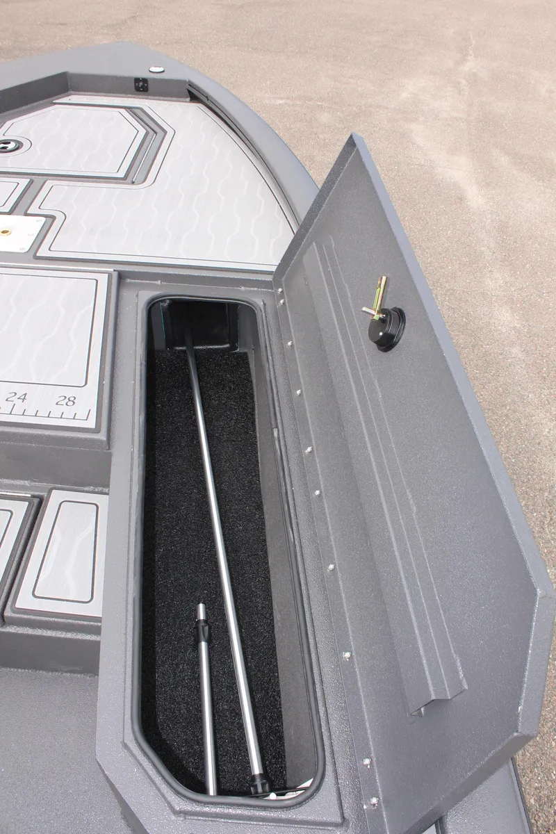 Slide: The Image of 2025 Avid 21 FSX boat storage compartment with open lid and interior view. - 26