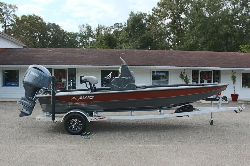 Slide: The Image of 2025 Avid 21 FSX boat on trailer, parked outside a building. - 5