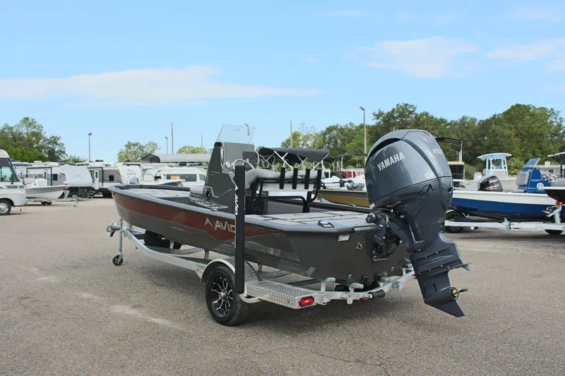 Slide: The Image of 2025 Avid 21 FSX boat with Yamaha motor on trailer in parking lot. - 8