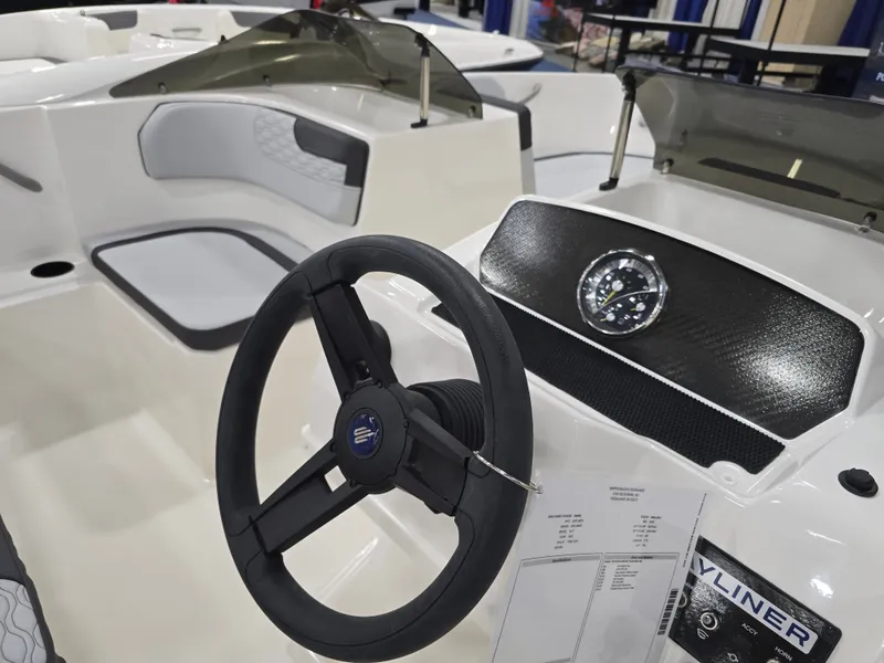 Slide: The Image of Interior view of 2025 Bayliner M17 with steering wheel and dashboard. - 10