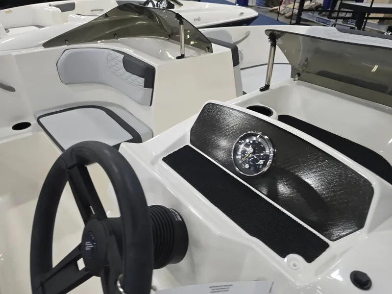 Slide: The Image of Interior view of 2025 Bayliner M17 with steering wheel and dashboard. - 11