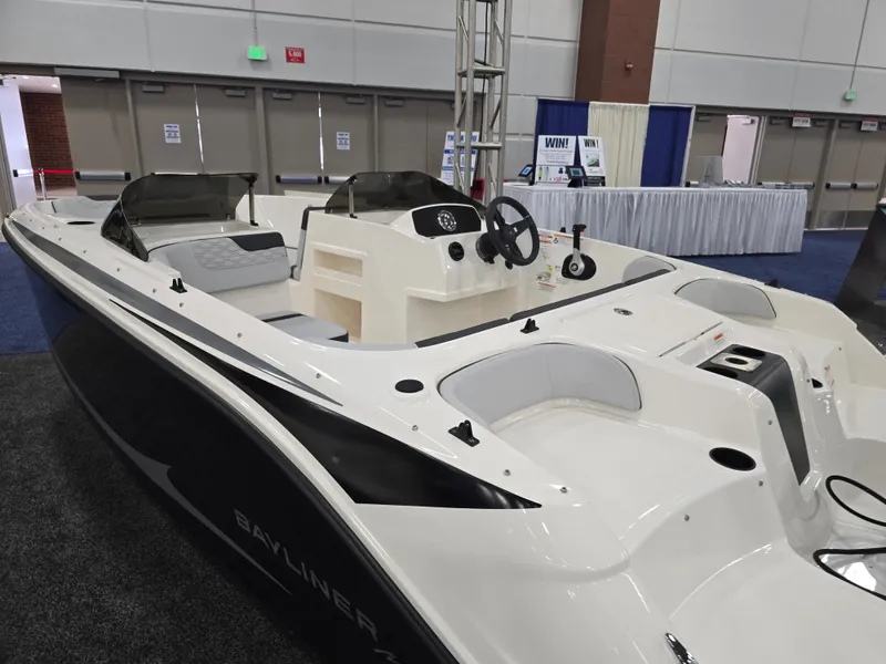Slide: The Image of Bayliner M17 2025 motorboat displayed at a trade show. - 18