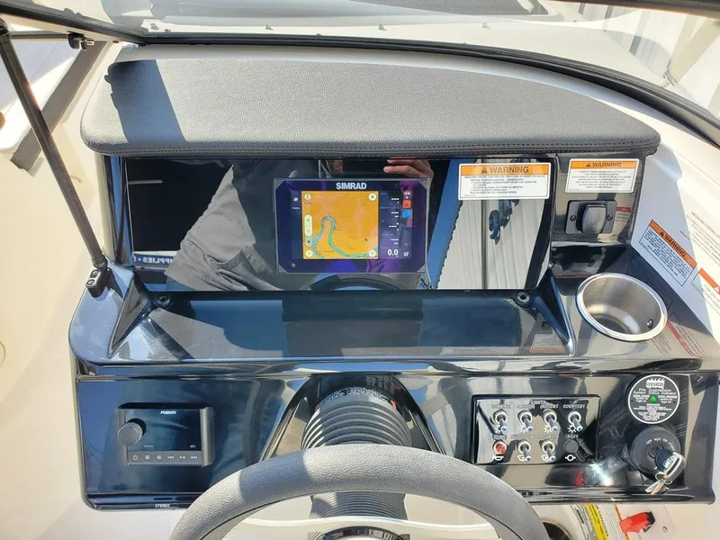 Slide: The Image of 2025 Sea Ray SPX 210 BR dashboard with navigation system and controls. - 20
