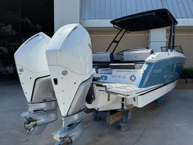 Slide: The Image of 2023 Cobalt R8 Outboard boat with dual engines, docked outdoors. - 10