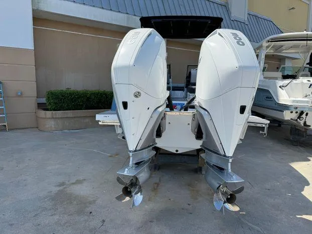 Slide: The Image of 2023 Cobalt R8 Outboard boat with dual engines, docked outdoors. - 11