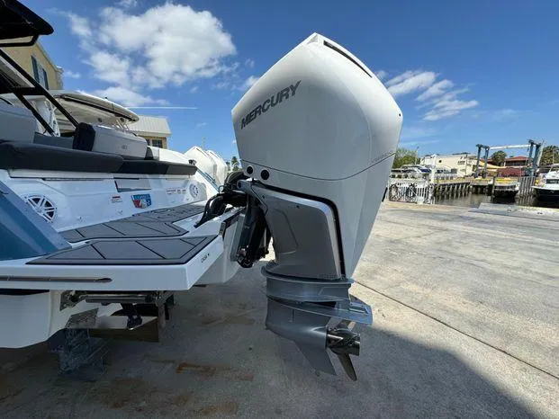 Slide: The Image of 2023 Cobalt R8 Outboard with Mercury engine, docked under a clear blue sky. - 14