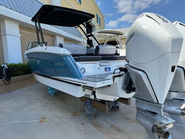 Slide: The Image of 2023 Cobalt R8 Outboard boat with dual engines, docked outdoors. - 15